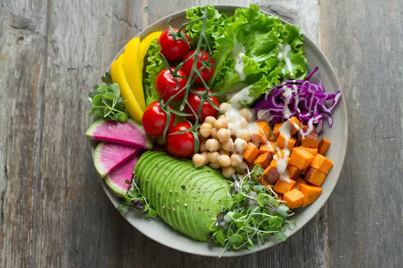 Overhead view of a colorful Buddha bowl with vegetables - AI photo calorie counter analysis